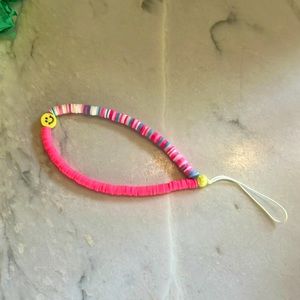 Adorable preppy smiley face detailed pink phone charm!